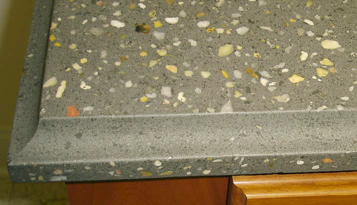 This countertops flat surfaces were ground and polished to expose the colorful aggregate. The curved edge was formed by casting the concrete against a piece of 3/4-inch round-over molding.