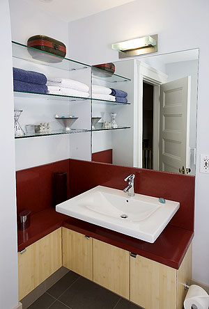Stone Soup Concrete used a bright red on this concrete countertop bathroom vanity.
