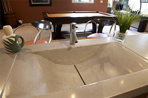A single line concrete drain in this sink gives the bathroom a modern upscale look.