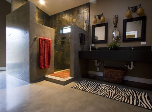 A sleek upscale concrete bathroom with animal print accents.