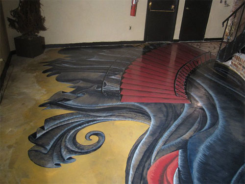 3-D effect of The Phantom of the Opera stained onto this concrete floor.