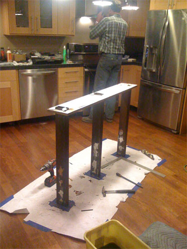 Reinforcing the heavy concrete countertop with steel supports.