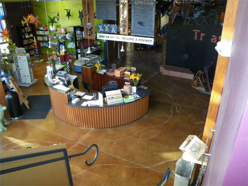 When ExplorationWorks approached me with this project they wanted to do an acid-stained river from the exterior through the front entryway and around the front-desk area of the museum.