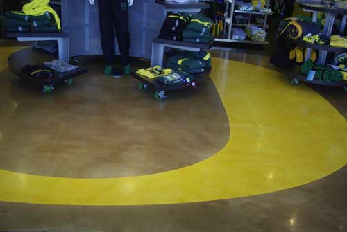 A closer look at the bright yellow O that was placed o this concrete floor with epoxy and stencils.