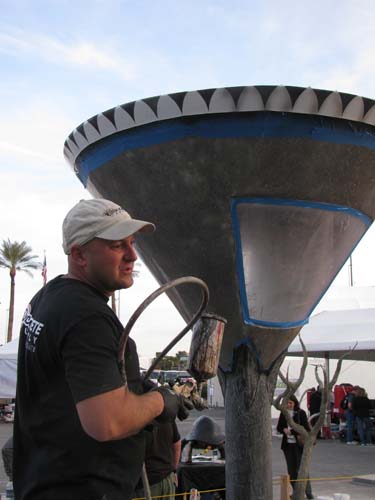 Jason Geiser putting some details into the sculpture at World of Concrete.