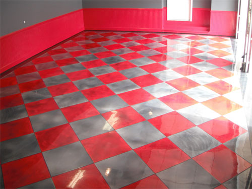 The finished concrete garage floor in gray and red.