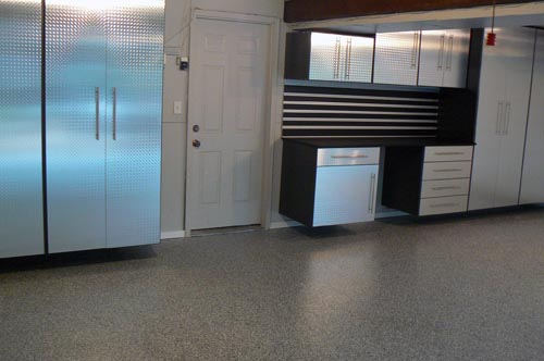 Versatiles Roll On Rock Epoxy and Polyurea floor coating system next to its cabinets and matching slat wall.