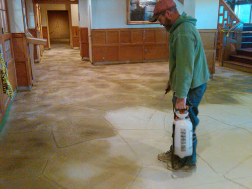 Applying the concrete stains to the floor in the ski resort.
