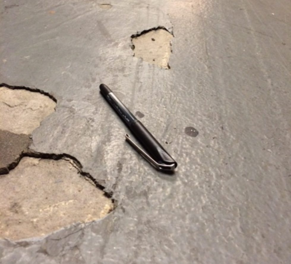 The pitted floors shown here with a pen next to them to show size.