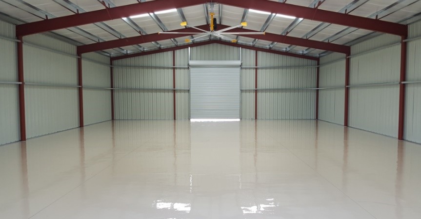 High-Solids Polyaspartic Top Coat by Versatile in a large warehouse space.