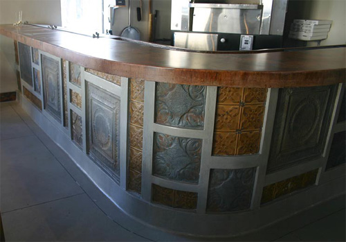 Concrete countertop at a bar with a curved edge to avoid pointed corners.
