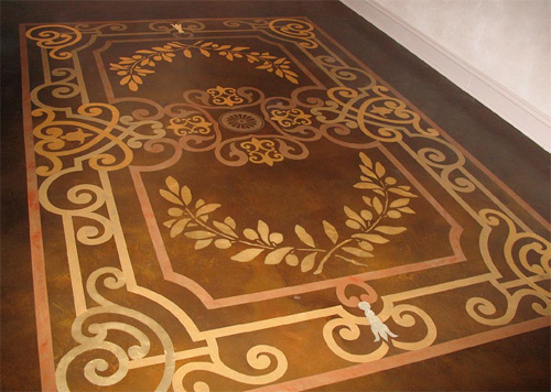 A concrete ornate design that was stained to make it look like an area rug.
