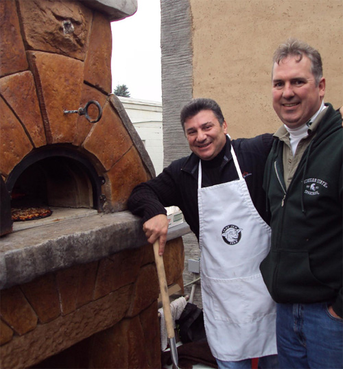 Mike Branch (right) and Carmin Parisi from Chicago Brick Oven monitor a pizza in a working decorative-concrete display oven at The Rental Branch.