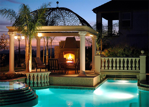 The central point of this pool deck is the fireplace.