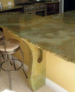 A concrete countertop at bar height with stools next to it.