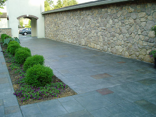 Ideal for patios, driveways or other expansive exteriors, this stamping technique is all about subtle variations in color and texture, resulting in a realistic stony finish.