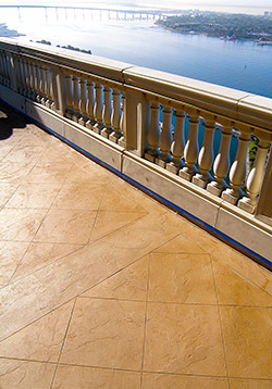 An overlay on a deck next to a railing that overlooks an expansive water view.
