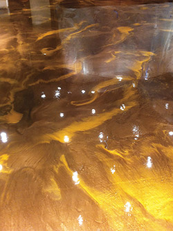 Metallic epoxy floor with a high-sheen that reflects the lights from above.
