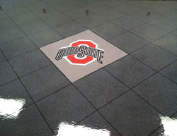 The Ohio State University logo was stenciled and stained onto this concrete floor.