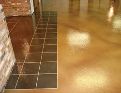 A yellow concrete stained floor in front of a fireplace.