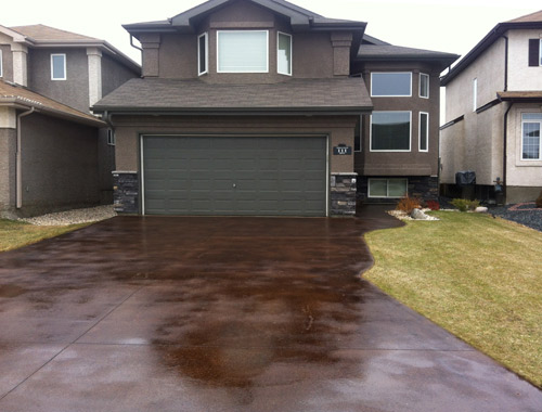 Randy Klassen, Winnipeg, Manitoba, grinds outdoors with equipment he bought for polishing inside. This is a driveway he ground and acid-stained. 