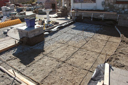Scarified concrete slab was used to create a mechanical bond for the layer of decorative concrete to grip.