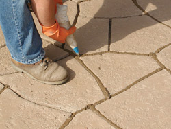 Polymer-modified grout is applied using a traditional masonry grout bag. Grout can be any color or left uncolored for a traditional look.