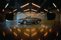 Polished concrete auto showroom with lights reflecting off the shine on the floor.