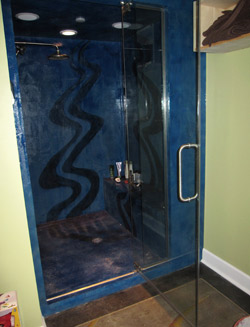 shower surround using concrete was hand painted and then sealed with a polyaspartic.