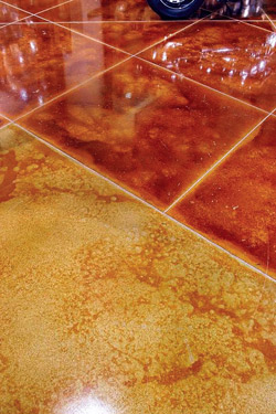 Concrete stained in contrasting colors a terracotta tile with gold border.
