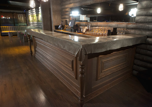 5Church a high end restaurant in Charlotte has a reception area concrete countertop mimicking a piece of fabric laying over a countertop.