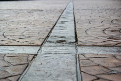 A close up look a the transition in colored stamped concrete.