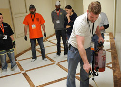 Applying acid stain with a sprayer on the floor in this building.