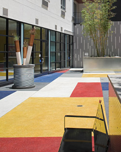 T.B. Penick & Sons Inc. created this vibrant San Diego courtyard with the help of white cement. Each section was seeded with an aggregate or glass material the same color as the integral shade. Photo courtesy of T.B. Penick & Sons Inc.