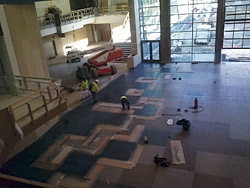 Dyed concrete in high school - Dyeing underway at Eisenhower High School, showing the masks and layout lines.