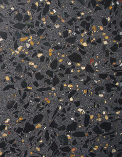Large exposed aggregate in a concrete wall - These wall panels at the Saint Louis Art Museum were ground and polished horizontally with traditional equipment to expose large aggregate before being installed vertically. Because they had to be cast outside in the winter, a tent was erected and heated to prevent the densifier from freezing.