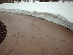 Sensor-controled heated walkway - Sensors control the temperature of the walkway at this Park City, Utah, house so that snow melts as soon as it hits. Eliminating freeze-thaw cycles and reducing damage from shovels helps concrete slabs last longer in cold climates. Photo courtesy of Architectural Concrete and Design - Sensors control the temperature of the walkway at this Park City, Utah, house so that snow melts as soon as it hits. Eliminating freeze-thaw cycles and reducing damage from shovels helps concrete slabs last longer in cold climates. Photo courtesy of Architectural Concrete and Design