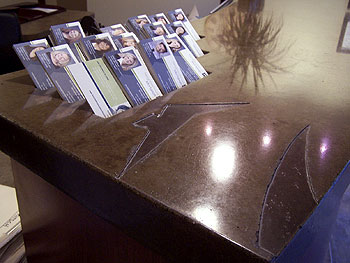 New Edge Design formed a commercially used concrete countertop with spaces for business cards formed within the slab.