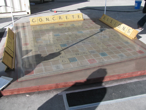 A larger than life Scrabble board with tiles made of concrete and stained to the appropriate colors and squares
