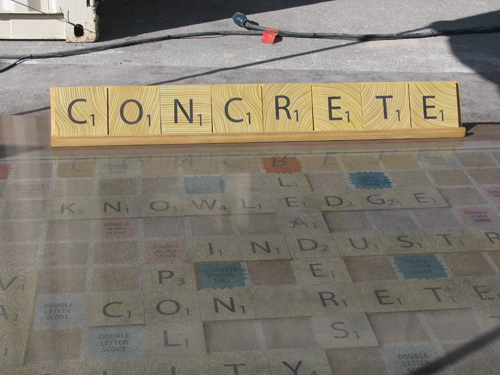 The word CONCRETE spelled out with concrete scrabble letters.