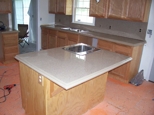 A kitchen island complete with concrete countertops.