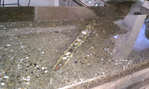 Aggregate has been added into the concrete countertop to compliment the edge form.