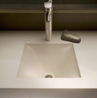 Sleek concrete sink with metal faucet.