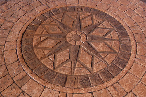 A design created using the Cobble Circle radial stamp set and a decorative center medallion from Specialty Concrete Products.