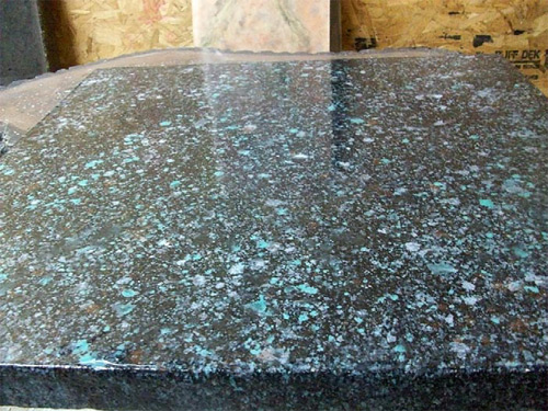 This countertop, created with a countertop overlay mix on 3/4-inch particle board, was colored by misting acrylic water-based stains in various colors onto the surface with a spray bottle. The work is protected by a 100 percent solids high-gloss UV-cured sealer. Photo courtesy of New Finish Technologies