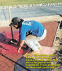 Woman using concrete stamps and concrete skins on a integrally colored concrete driveway approach.