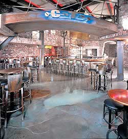 A bar is transformed with natural looking elements on the floor created with blues and browns.