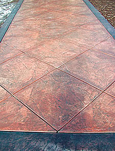 Burgundy band in stamped concrete
