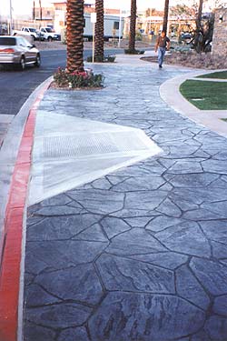 Increte Systems flagstone shaped stamp used on this city sidewalk with contrasting colors in dark grey and black. 