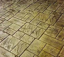 To eliminate unwanted lines in a stamped concrete project run the pattern at an angle. 